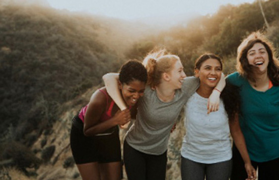 Group of friends laughing together outdoors